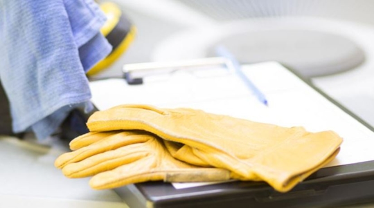 gloves and clipboard on air conditioning unit
